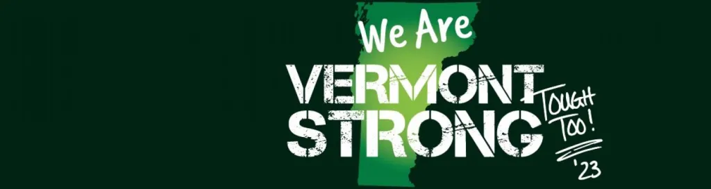 One dark-green license plates: We Are Vermont Strong in white letters; state diagram in lighter green behind it